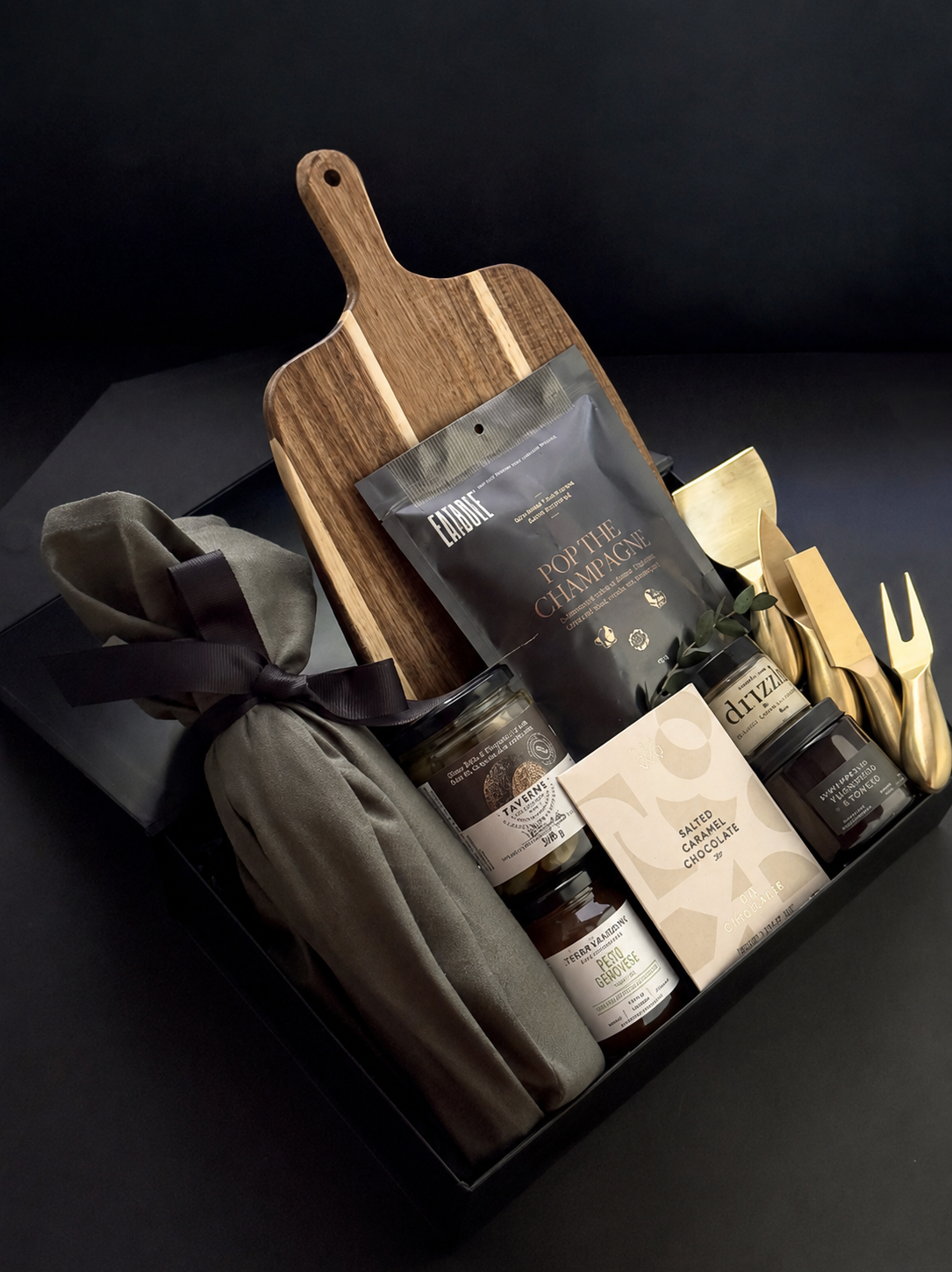 Charcuterie gift box with cutting board, champagne popcorn, and gold cheese tools